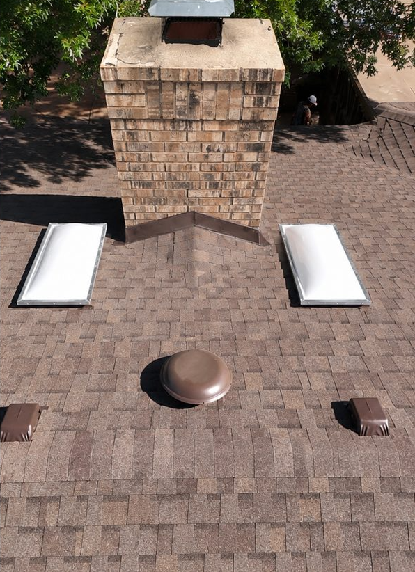 Chimney with new flashing and fresh shingles, after restoration