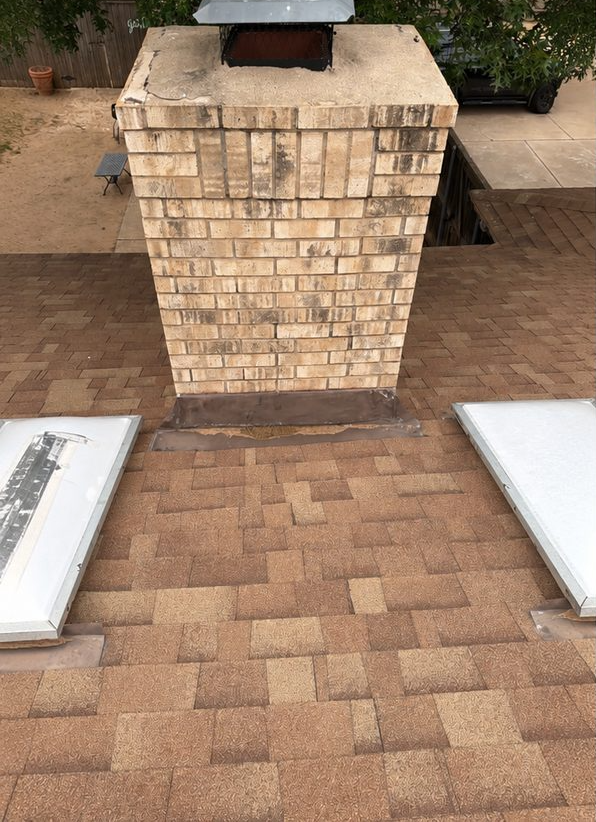 Chimney with failing flashing and staining, before restoration